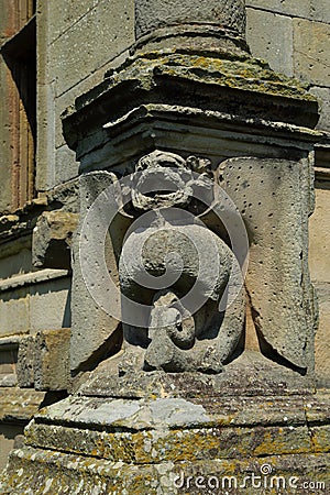 Grotesque gargoyle carving in stone on an old house Stock Photo