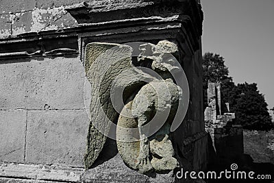 Grotesque gargoyle carving in stone on an old house Stock Photo