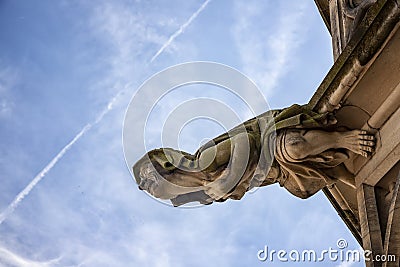 Grotesque gargoyle at the gothic tower a part of the cathedral in city Ulm, Germany Editorial Stock Photo