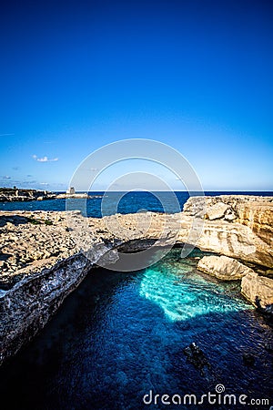 The Grotta della Poesia in the Puglia region of southern Italy with clear waters and a crystal clear sky Stock Photo