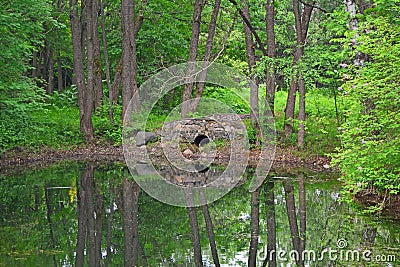 Grotto on a pond in Dendrology garden in Pereslavl-Zalessky city Stock Photo
