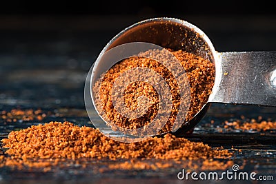 Ground Cayenne Pepper Spilled from a Teaspoon Stock Photo