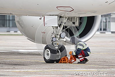 A ground control manager sets the wheel chock Stock Photo
