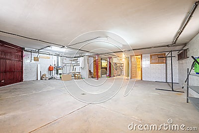 Ground floor of a detached house dedicated to a garage with a cement floor Stock Photo