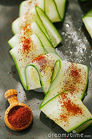 Ground Red Sumac Berries sprinkled on cucumber slice Stock Photo