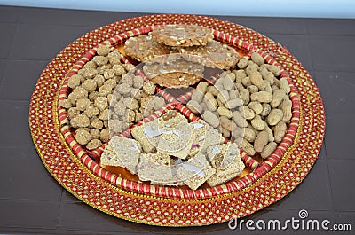 Groundnuts, ground nuts gachak sesame seeds rewari and gachak in a decorative plate lohari festival winter India. Stock Photo