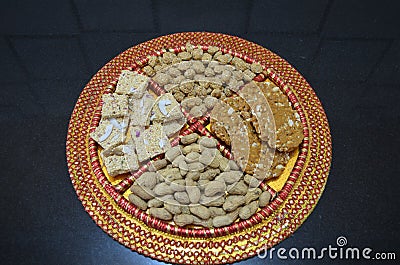 Groundnuts, ground nuts gachak sesame seeds rewari and gachak in a decorative plate lohari festival winter India. Snack Stock Photo