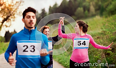 A group of multi generation people running a race competition in nature. Stock Photo