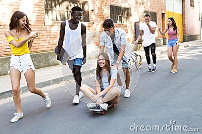 Group of active teenagers making recreational activity in an urban area. Stock Photo