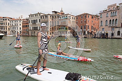 Group of active tourists stand up paddling on sup boards at Grand Canal, Venice, Italy. Editorial Stock Photo