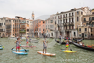 Group of active tourists stand up paddling on sup boards at Grand Canal, Venice, Italy. Editorial Stock Photo