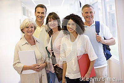 A group of adult students with backpacks standing Stock Photo