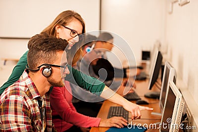 Group of adults learning computer skills. Intergenerational tran Stock Photo