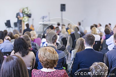 Group of Adults Listening to the Host on Stage During a Conference Editorial Stock Photo