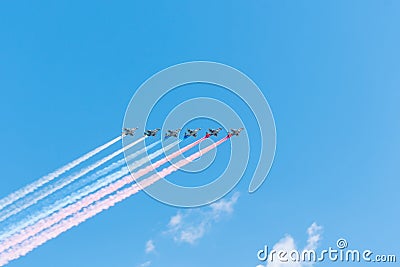 Group of airplanes makes Russian flag in the sky with colorful smoke, red, blue and white. Editorial Stock Photo
