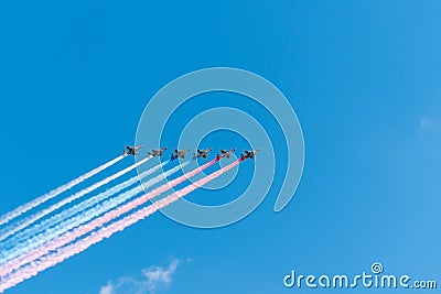 Group of airplanes makes Russian flag in the sky with colorful smoke, red, blue and white. Editorial Stock Photo