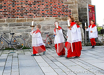 A group of Altar Boys leave church on catholic holiday Mary's Asumption Editorial Stock Photo