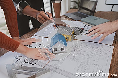 Group architects and engineers build houses and conference buildings together to design and build structures, sketch house plans Stock Photo