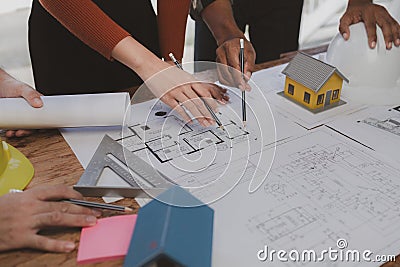 Group architects and engineers build houses and conference buildings together to design and build structures, sketch house plans Stock Photo
