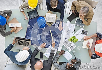 Group of Architects Planning with Blueprint Stock Photo