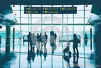 Group of Asian business people, passenger, traveler and group tourist walking in font of gate at Hong Kong International Airport. Editorial Stock Photo