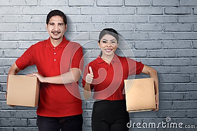 Group of asian courier team carry the parcel Stock Photo