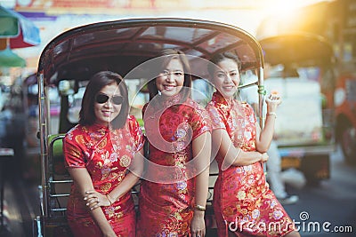 Group of asian woman wearing chinese tradition clothes toothy smiling face happiness emotion and hand sign i love you Stock Photo