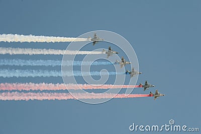 A group of assault plane Sukhoi Su-25 Grach NATO reporting name: `Frogfoot` in the sky smoke colors of Russian flag at the rehea Editorial Stock Photo