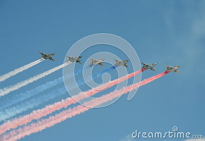 A group of assault plane Sukhoi Su-25 Grach NATO reporting name: `Frogfoot` in the sky smoke colors of Russian flag at the rehea Stock Photo