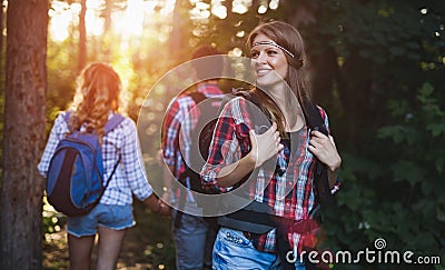 Group of backpacking hikers going for forest trekking Stock Photo