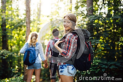 Group of backpacking hikers going for forest trekking Stock Photo