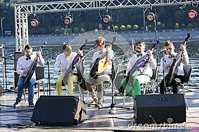 Group of bandurists playing ethno music on the beach, Dnipro river on a background. Bandura is an Ukrainian national musical Editorial Stock Photo