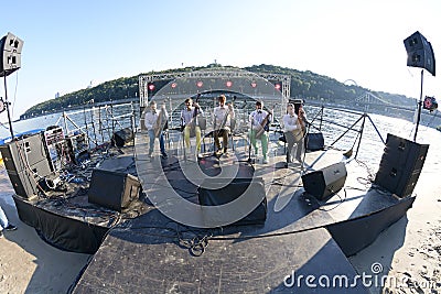 Group of bandurists playing ethno music on the beach, Dnipro river on a background. Bandura is an Ukrainian national musical Editorial Stock Photo