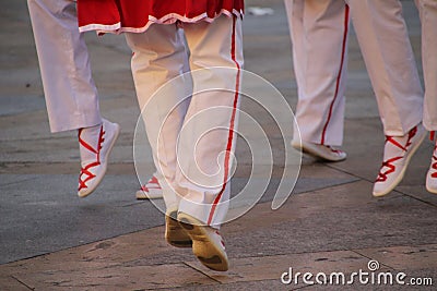 Group of Basque folk dancers performing in a vibrant outdoor festival Stock Photo