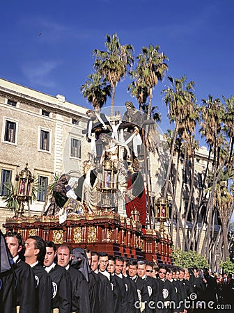 A group of bearers (called Costaleros) carrying a religious float Editorial Stock Photo