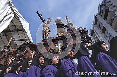 A group of bearers (called Costaleros) carrying a religious float Editorial Stock Photo