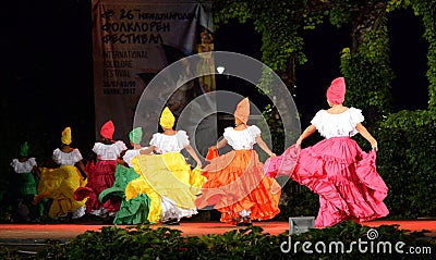 Colombian folklore dancers waving skirt dancing at night outdoor stage Editorial Stock Photo