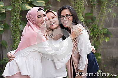 Group of best fiend muslim girl smiling at camera while hugging Stock Photo