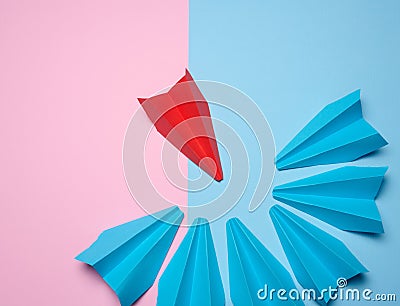 A group of blue paper boats surrounded one red boat, the concept of bullying, search for compromise. Top view.A group of blue Stock Photo