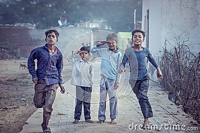 Group of boisterous Indian children running for photograph in Agra, Uttar Pradesh, India Editorial Stock Photo