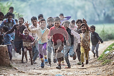 Group of boisterous Indian children running for photograph in Agra, Uttar Pradesh, India Editorial Stock Photo