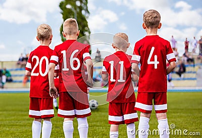 Group of boys football soccer players standing together on green Stock Photo