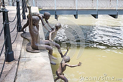 Group of boys jumping statue into the the River Stock Photo