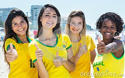 Group of brazilian soccer fans showing thumbs outdoor in the city Stock Photo