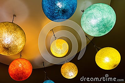 Group of bright colorful round lanterns of paper electric close-up of yellow blue holiday base Stock Photo