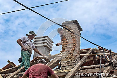 Group of builders working on the roof of the house. Zrenjanin, Serbia. Editorial Stock Photo