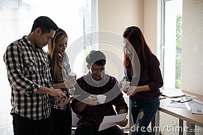 A group of business men and women talking to each other. Have a Stock Photo