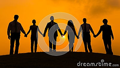 Group of business partner hold hand together in silhouette with sunrise background Stock Photo