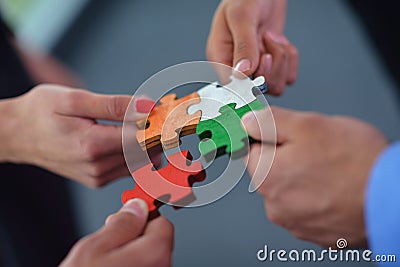 Group of business people assembling jigsaw puzzle Stock Photo