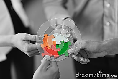 Group of business people assembling jigsaw puzzle Stock Photo